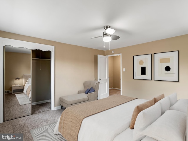 bedroom with carpet floors, baseboards, a ceiling fan, and a closet