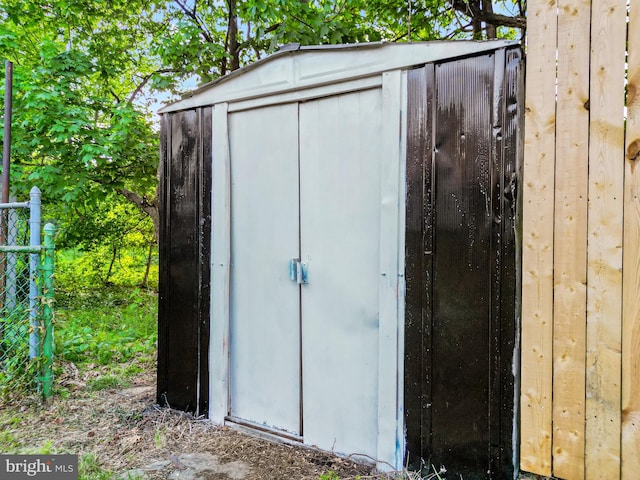 view of shed featuring fence