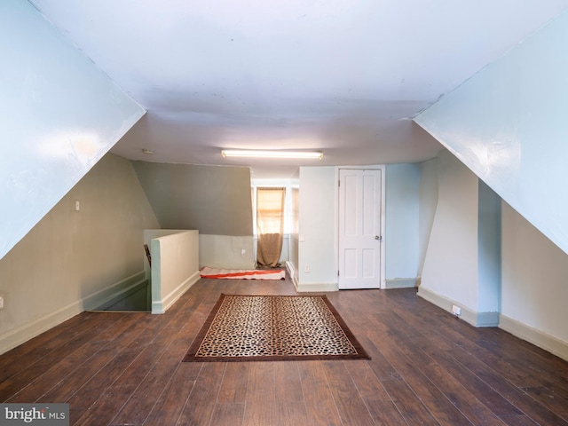 additional living space with hardwood / wood-style flooring and baseboards