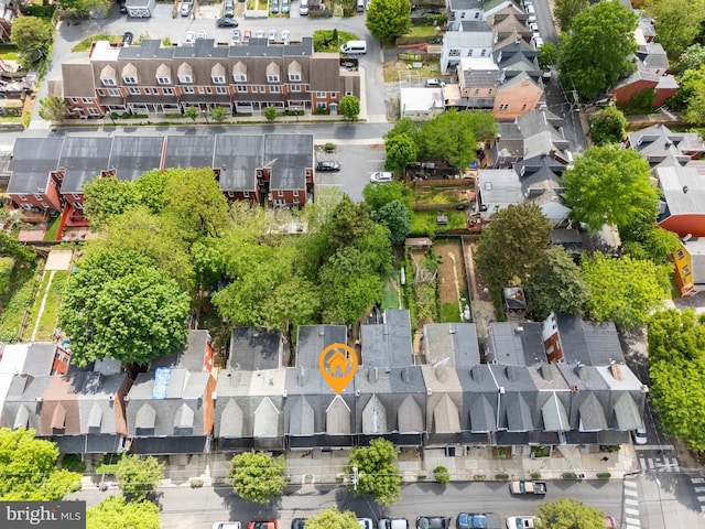 aerial view of property and surrounding area featuring nearby suburban area