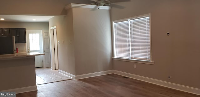 unfurnished dining area featuring a ceiling fan, light wood-style floors, recessed lighting, and baseboards