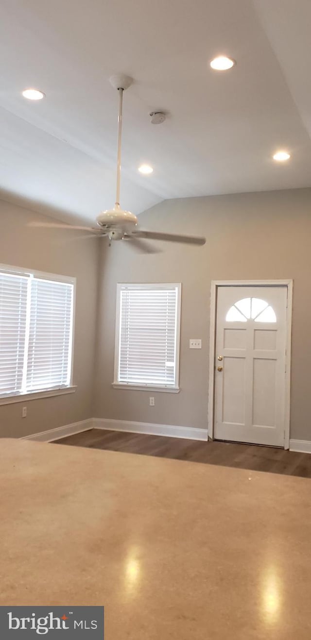 foyer entrance featuring lofted ceiling, wood finished floors, recessed lighting, ceiling fan, and baseboards