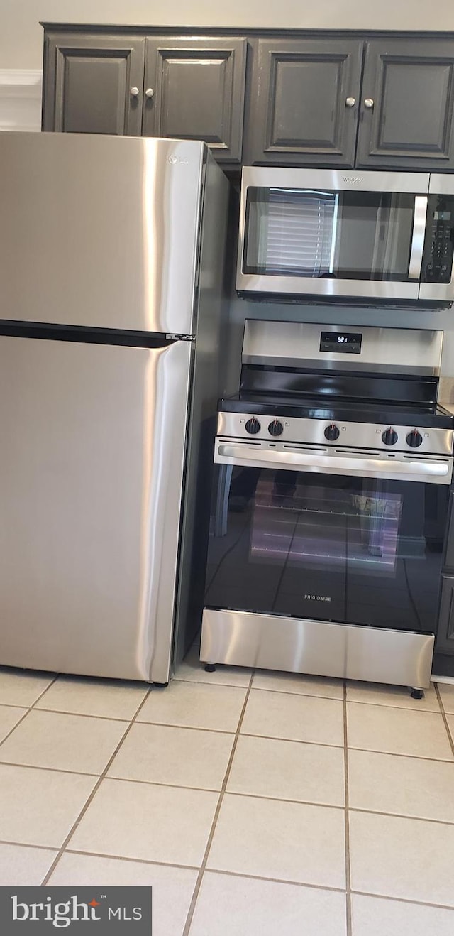 kitchen featuring light tile patterned floors and stainless steel appliances