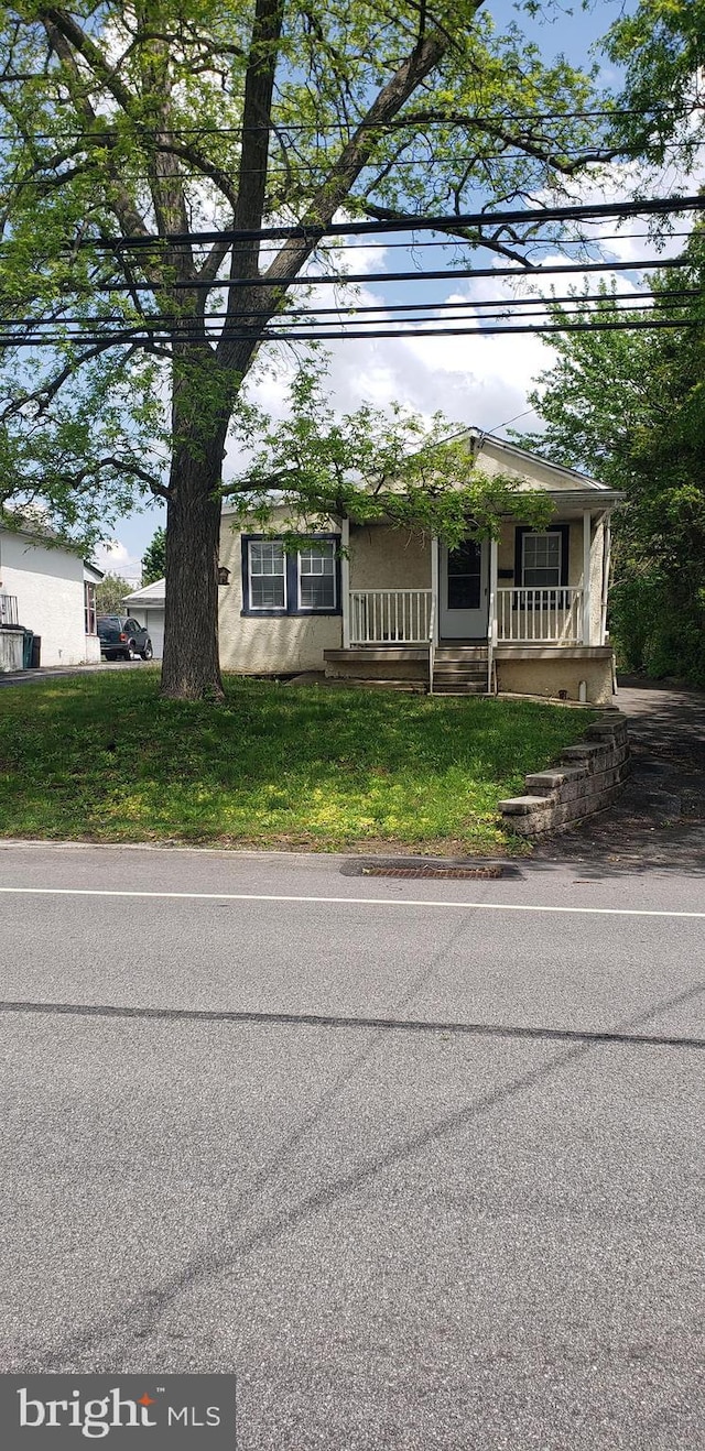 view of front of home featuring stucco siding and a porch