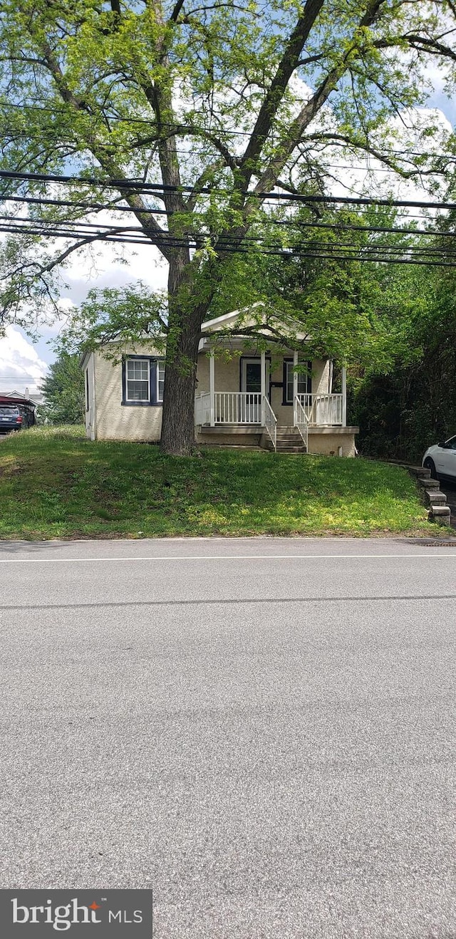 obstructed view of property featuring covered porch