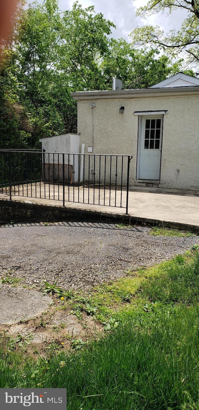 exterior space featuring fence and stucco siding