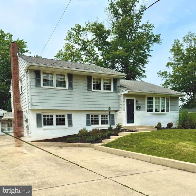 10 Meadow Ln, West Deptford, NJ 08096 - split level home featuring brick siding, a chimney, and a front lawn