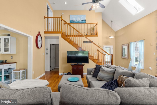 21 Heisler Ave, Charlestown, MD 21914 - living room featuring high vaulted ceiling, stairs, a skylight, wood finished floors, and a ceiling fan