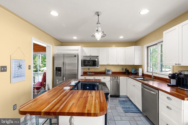 21 Heisler Ave, Charlestown, MD 21914 - kitchen featuring butcher block counters, appliances with stainless steel finishes, a sink, a kitchen island, and white cabinetry