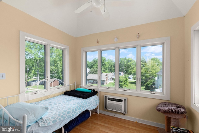 21 Heisler Ave, Charlestown, MD 21914 - bedroom featuring wood finished floors, vaulted ceiling, a wall unit AC, and a ceiling fan