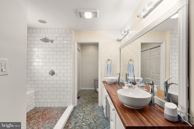 21 Heisler Ave, Charlestown, MD 21914 - full bathroom featuring a tile shower, double vanity, and baseboards