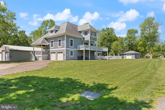 21 Heisler Ave, Charlestown, MD 21914 - back of property with an attached garage, a yard, driveway, and an outbuilding