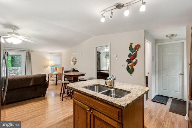 473 Cumberland Rd, Oakland, MD 21550 - kitchen featuring light wood-style flooring, a ceiling fan, a sink, brown cabinetry, and lofted ceiling