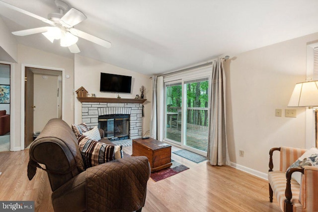 473 Cumberland Rd, Oakland, MD 21550 - living room with lofted ceiling, baseboards, a stone fireplace, ceiling fan, and light wood-type flooring