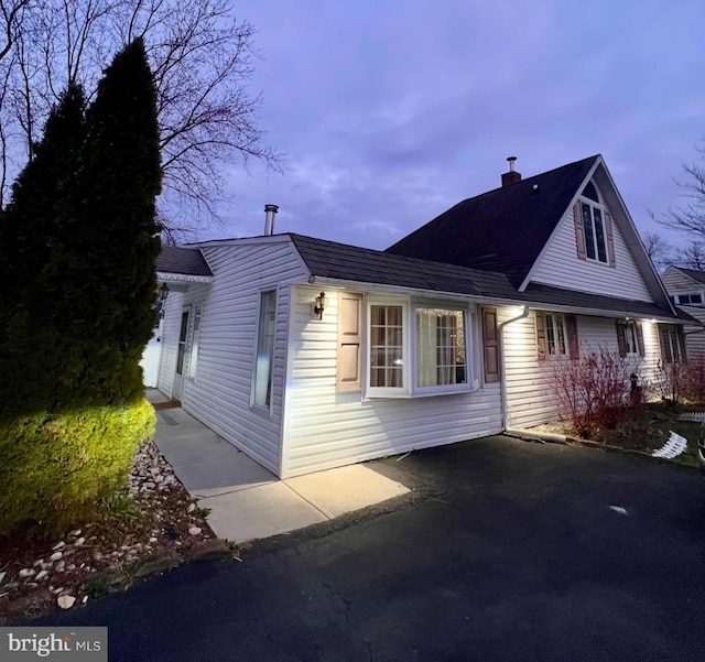 18 River Ln, Levittown, PA 19055 - view of side of home featuring a chimney and roof with shingles