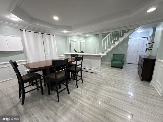 18 River Ln, Levittown, PA 19055 - dining room with a decorative wall, ornamental molding, stairway, a tray ceiling, and a baseboard heating unit