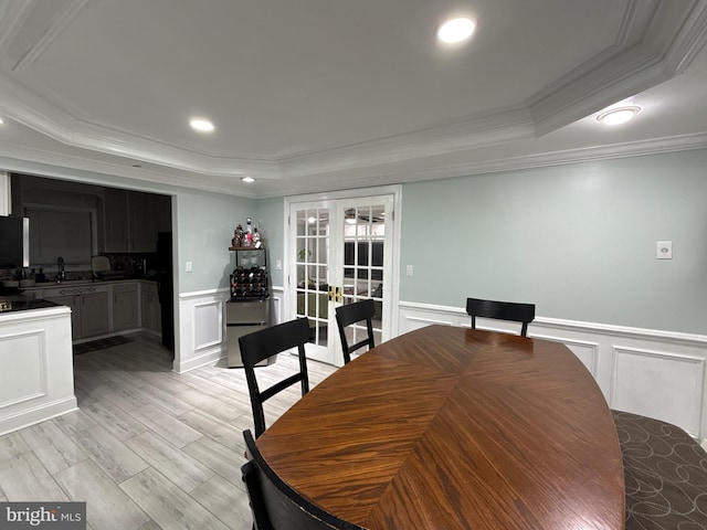 18 River Ln, Levittown, PA 19055 - dining area featuring a decorative wall, a tray ceiling, ornamental molding, a wainscoted wall, and french doors