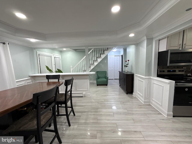 18 River Ln, Levittown, PA 19055 - dining space featuring crown molding, a decorative wall, stairs, a tray ceiling, and recessed lighting