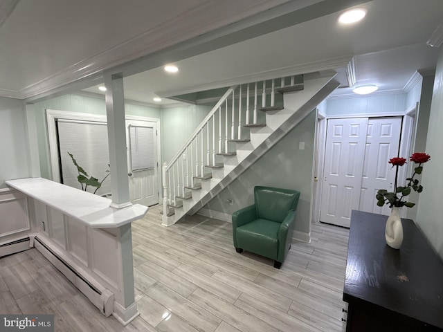 18 River Ln, Levittown, PA 19055 - interior space with crown molding, a baseboard heating unit, stairs, light wood-style floors, and baseboards