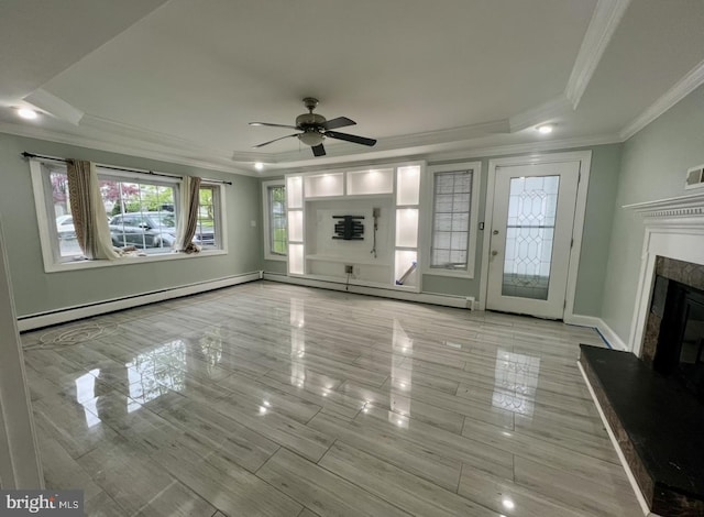 18 River Ln, Levittown, PA 19055 - unfurnished living room featuring a tray ceiling, crown molding, baseboard heating, a high end fireplace, and ceiling fan