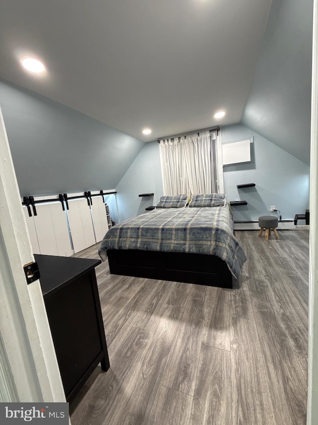 18 River Ln, Levittown, PA 19055 - bedroom with lofted ceiling, wood finished floors, baseboard heating, and baseboards