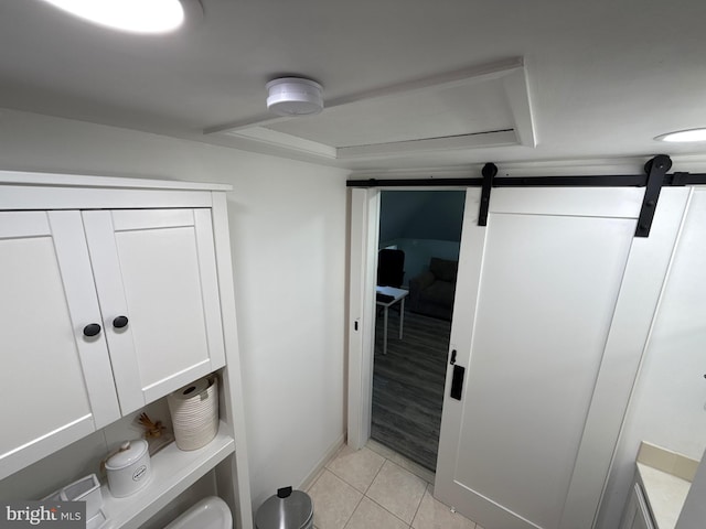 18 River Ln, Levittown, PA 19055 - interior space with a barn door, light tile patterned floors, and baseboards