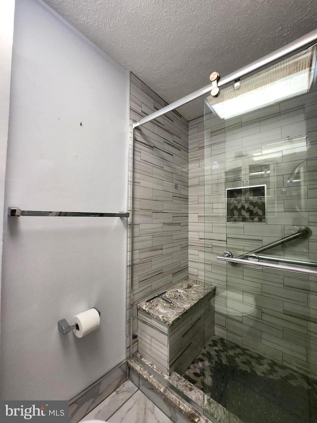 102 Suburban Ter, Stratford, NJ 08084 - full bath with a stall shower, marble look tiles, and a textured ceiling
