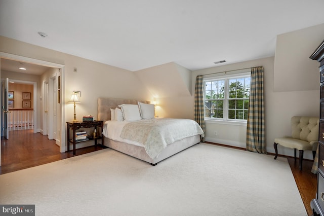 bedroom with wood finished floors and baseboards