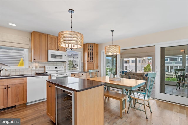 113 Henlopen Dr, South Bethany, DE 19930 - kitchen with white appliances, wine cooler, a sink, decorative backsplash, and light wood-style floors