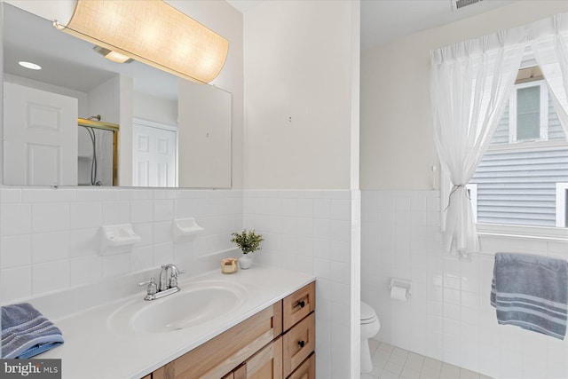 113 Henlopen Dr, South Bethany, DE 19930 - full bath featuring toilet, tile walls, vanity, tile patterned floors, and wainscoting