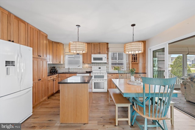 113 Henlopen Dr, South Bethany, DE 19930 - kitchen with white appliances, a sink, a chandelier, a center island, and backsplash