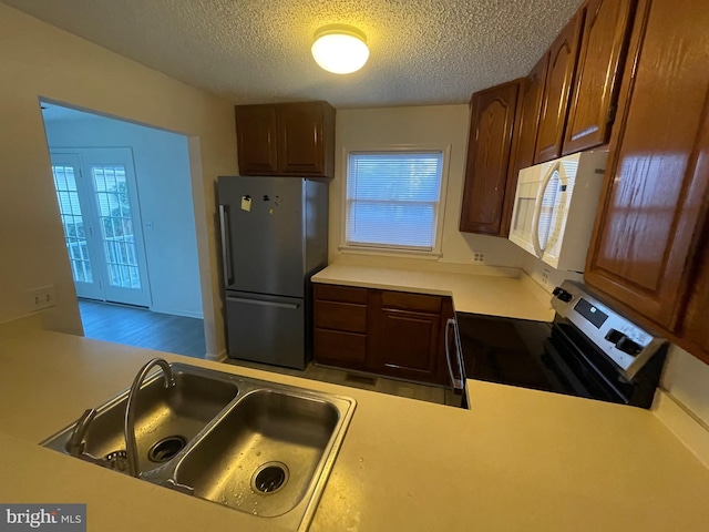 409 Connecticut Ave, Norfolk, VA 23508 - kitchen featuring a sink, stainless steel appliances, a textured ceiling, and light countertops