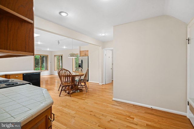 dining space with light wood-style floors and baseboards
