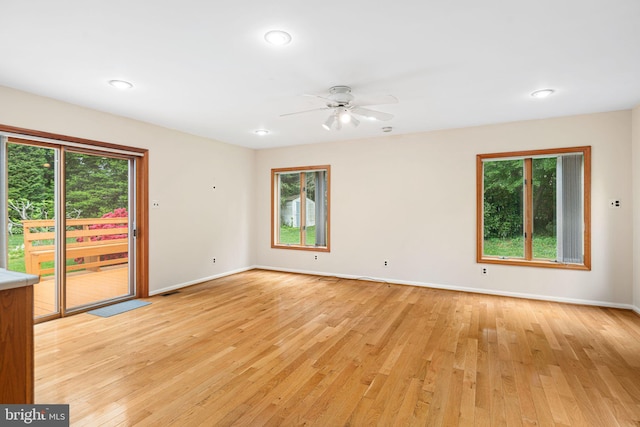 spare room featuring baseboards, light wood-style flooring, a ceiling fan, and recessed lighting
