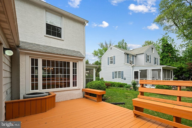 wooden deck featuring a sunroom
