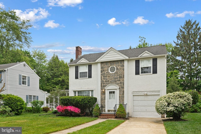 view of front facade with stone siding, an attached garage, a chimney, concrete driveway, and a front lawn