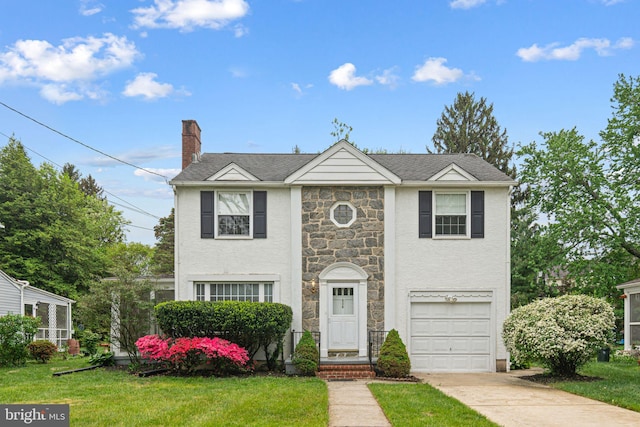 view of front facade with stone siding, concrete driveway, a front yard, and an attached garage