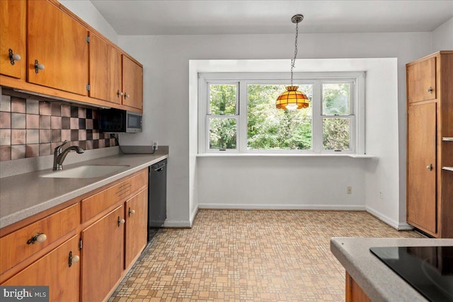 8815 Beauchamp Dr, Alexandria, VA 22309 - kitchen with a sink, black dishwasher, brown cabinets, decorative backsplash, and baseboards