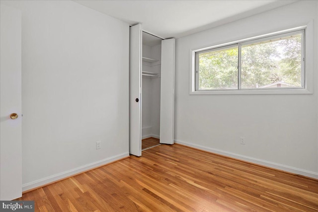 8815 Beauchamp Dr, Alexandria, VA 22309 - unfurnished bedroom with light wood finished floors, baseboards, and a closet