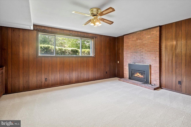 8815 Beauchamp Dr, Alexandria, VA 22309 - unfurnished living room featuring a ceiling fan, a fireplace, carpet flooring, wood walls, and baseboards