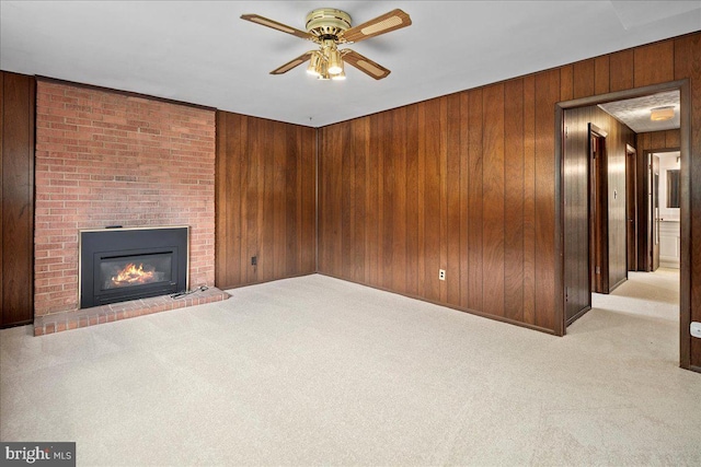 8815 Beauchamp Dr, Alexandria, VA 22309 - unfurnished living room with wooden walls, carpet, ceiling fan, and a fireplace