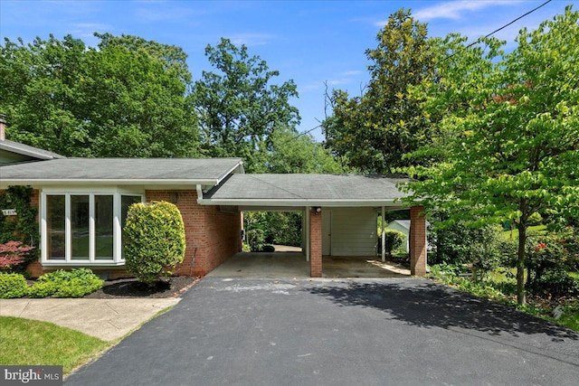 8815 Beauchamp Dr, Alexandria, VA 22309 - view of parking featuring driveway and an attached carport