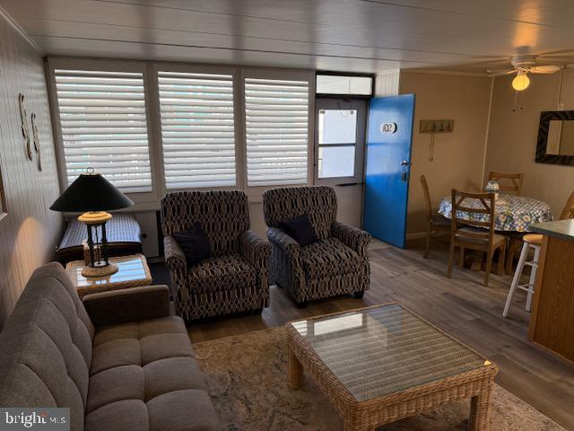 11 71st St Unit 102, Ocean City, MD 21842 - living room with a ceiling fan, wood finished floors, and ornamental molding