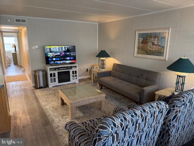 11 71st St Unit 102, Ocean City, MD 21842 - living area with crown molding, hardwood / wood-style floors, and baseboards