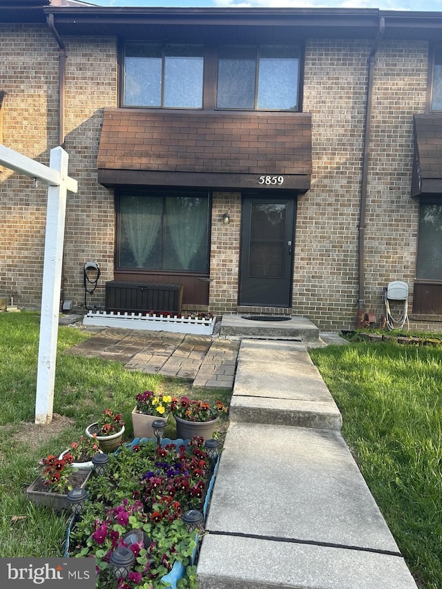 view of exterior entry featuring brick siding