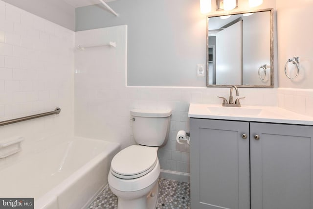 3712 N Rosser St Unit 201, Alexandria, VA 22311 - bathroom featuring toilet, vanity, wainscoting, washtub / shower combination, and tile walls
