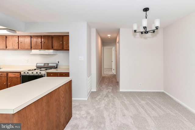 3712 N Rosser St Unit 201, Alexandria, VA 22311 - kitchen featuring gas range gas stove, under cabinet range hood, light countertops, a chandelier, and light carpet