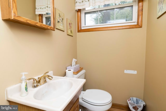 bathroom with toilet and vanity