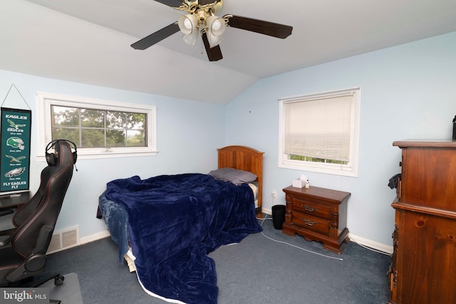 carpeted bedroom featuring baseboards, ceiling fan, visible vents, and vaulted ceiling