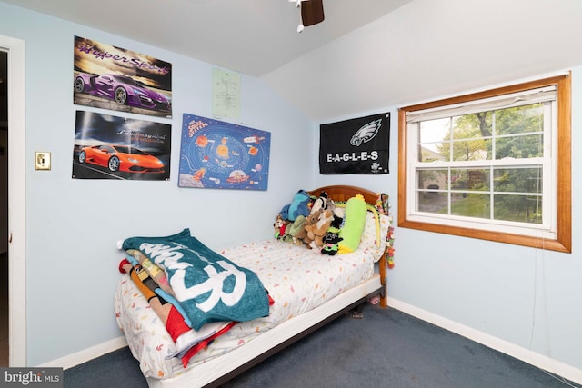 carpeted bedroom with vaulted ceiling, baseboards, and a ceiling fan